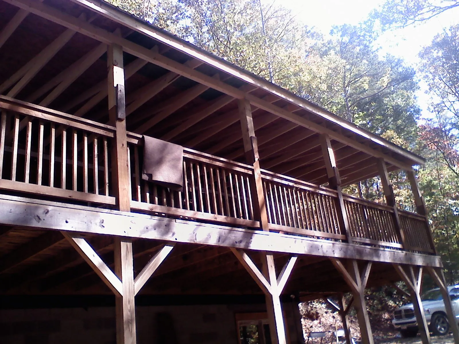 Timber framing under a new elevated porch and deck — Roof Leak Repair in New England by Roofing Brothers